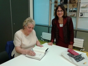 Lindsey Davis signing a copy of her book for Margaret George, author of Tudor novels